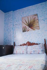a bedroom with a bed with a blue wall at Happy Home Dream Surf in Imsouane
