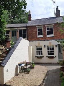 a house with a table and chairs in front of it at Beautiful Georgian cottage within a private walled garden in Oakham