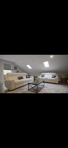 a living room with two couches and a coffee table at Luxury Lakehouse on Oneida Lake in Blossvale +38 photos