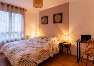 a bedroom with a bed and a window at Le Carrousel Avec Parking Privé in Dijon