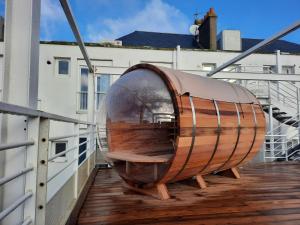 a wooden boat sitting on a balcony of a building at Hôtel Arc en Ciel et SPA Les Sables d'Olonne in Les Sables-d'Olonne +4 photos