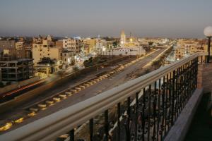 a view from a balcony of a city at night at Queens Valley Hotel in Luxor