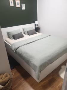 a large white bed with two pillows on it at Apartma Thermos in Krapinske Toplice +33 photos