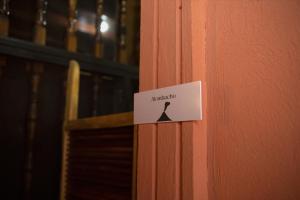 a sign on the door of a building with a hanger at Hostal Don Gato in Granada
