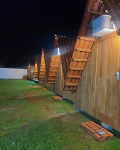 a row of wooden fences in a field at night at Cabana com Ar condicionado e area de cozinha e banheiro compartilhado a 10 minutos do Parque Beto Carrero in Penha