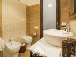 a bathroom with a white sink and a toilet at Casa Anacleto in Iglesias