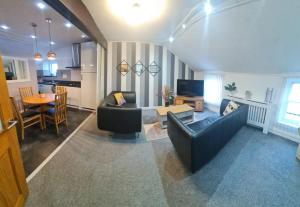 a living room with a couch and a table at Ulverston Town Centre Flat (2 Bedrooms) in Ulverston