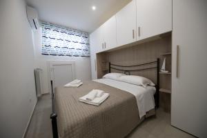 a bedroom with a bed with two towels on it at Plume Apartment by Wonderful Italy in Bari
