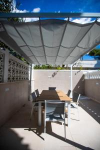 a table and chairs under an umbrella on a patio at Plume Apartment by Wonderful Italy in Bari