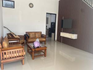 a living room with furniture and a flat screen tv at Jasmine 37 House 