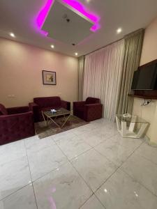 a living room with purple lights on the ceiling at فندق راية الشلال in Hafr Al-Batin +102 photos