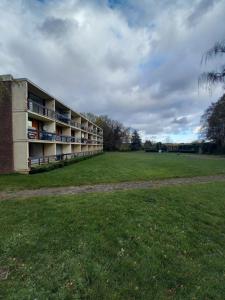 an empty building with a field in front of it at Ap5 Nature Ardennes Economy class apartment in La Calamine