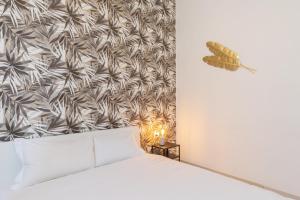a bedroom with a white bed and a wall at Duomo - Citylife Pink Vintage APT center Milan in Milan