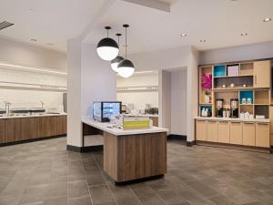 a lobby of a store with a counter and lights at Home2 Suites By Hilton Atlanta Airport College Park in Atlanta