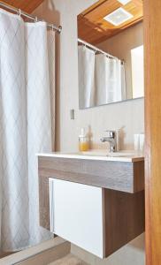 a bathroom with a sink and a mirror at Heritage Residences Santo Domingo in Santo Domingo