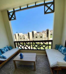 a room with two couches and a large window at Luxury Beach Frontage Studio- Non Egyptians only in Hurghada