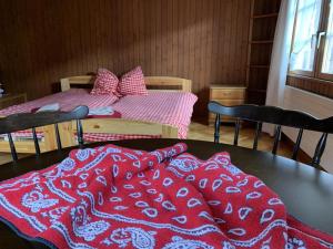 a bedroom with a bed with red and white blankets at Revier Hazzo's Biasca in Hätzingen