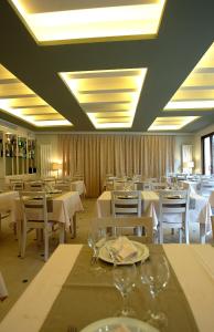 a dining room with white tables and white chairs at Hotel La Fonda Moreno in Morella