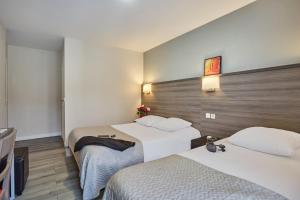 Postel nebo postele na pokoji v ubytování Huni Hôtel