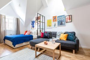 a living room with a couch and a table at TurnKey I Charles Square Apartments in Prague