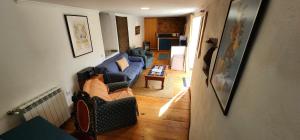 a view of a living room with a blue couch at A Quinta da Colina Adega in Castanheira de Pêra