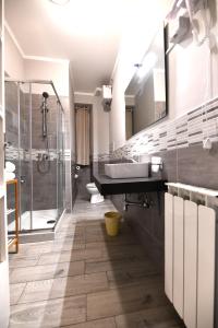 a bathroom with a sink and a shower at Hotel Bristol in Trieste