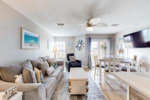 a living room with a couch and a table at Grand Beach Resort in Gulf Shores