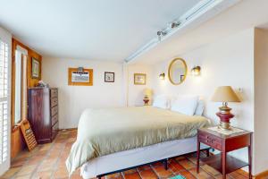 a bedroom with a bed and a table and a mirror at Audrey Leigh in Newburyport