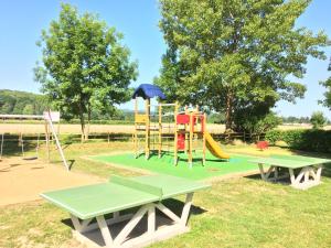 a park with a playground with a slide at Camping Pyrénées Nature in Oloron-Sainte-Marie
