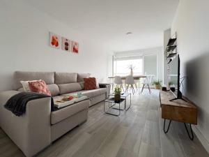 a living room with a couch and a table at Apartamentos Gredos 304 in Jaraiz de la Vera