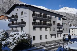 a large white building with snow on the ground at Quality Hosts Arlberg - Hotel Goldenes Kreuz B&B in Sankt Anton am Arlberg