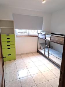 a room with two bunk beds and a tiled floor at Gohyssart 51b 2 Bruxelles-Charleroi-airport in Charleroi