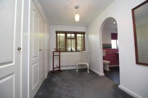 a hallway with a room with a toilet and a window at Highfields Holidays bed & breakfast in Peterborough