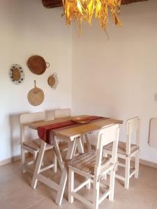 a dining room with a wooden table and chairs at Casa Inkill Huasi in Tilcara