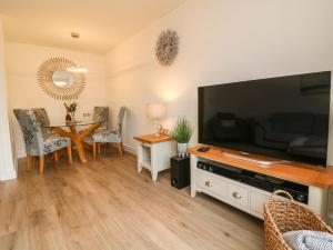 a living room with a large flat screen tv at Harley's Hideaway in Appledore