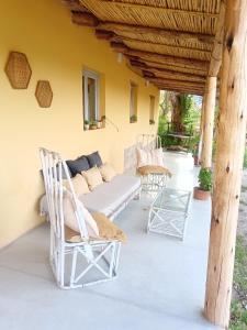 a patio with a couch and chairs on it at Casa Inkill Huasi in Tilcara