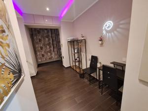 a room with a hair salon with purple lighting at Aircraft services rooms in Naples