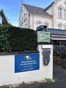 a sign in front of a building with a house at Boardinghouse am Herforder Tor für 8 Personen auf 185 m2 in Bad Salzuflen