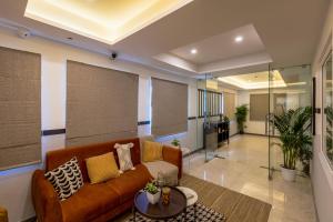 a living room with a couch and a table at Olive Hebbal - by Embassy Group in Bangalore
