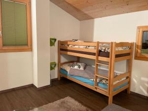 a room with two bunk beds in a room at Chalet Sträba in Bellwald