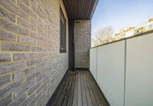 a brick wall next to a wooden deck at The Brixton residence in London