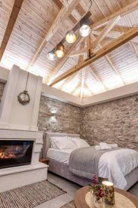 a bedroom with a bed and a fireplace at Villa Ntora in Xylopároikon