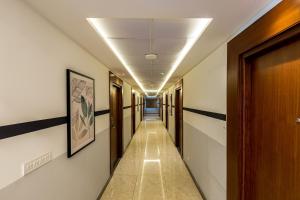 a corridor of a hallway with doors and a hallwayngth at Olive Hebbal - by Embassy Group in Bangalore