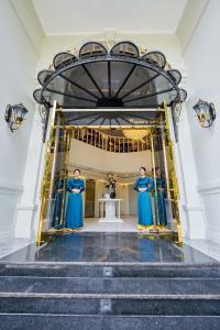 a group of women standing in front of a doorway at La Belle Vie Boutique Hotel in Da Nang