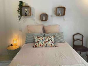 a bedroom with a bed with pillows on it at Charming Studio to Venelles 10 minutes from Aix in Venelles