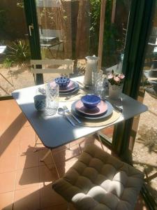 a white table with plates and dishes on it at Charming Studio to Venelles 10 minutes from Aix in Venelles