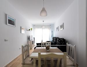 a dining room and living room with a table and chairs at Casa Nana - Playa Santiago in Playa de Santiago