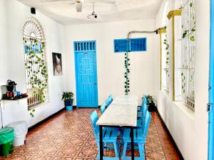 a room with a table and blue doors at Hotel Kasaya Real in Santa Marta
