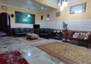 un grand salon avec des canapés et une télévision dans l'établissement Kulim Hi-Tech Hospital Homestay, à Kulim