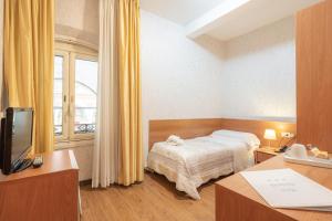 Postel nebo postele na pokoji v ubytování Hotel Donatello